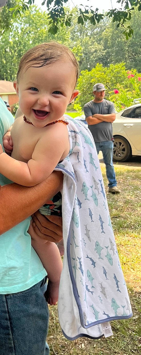 Nash is registered to the contest to win money with this photo: baby, car, child, community, event, fun, gesture, grass, green, happy, headwear, joy, leisure, people, person, photograph, pink, recreation, smile, summer