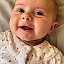 Léonie participe au concours pour gagner de l'argent avec cette photo : baby, smiling, face, child, infant, clothing, polka_dot, white, cute, portrait, closeup, happy, lying_down, soft, young_child, indoors, skin, head, eyes, mouth