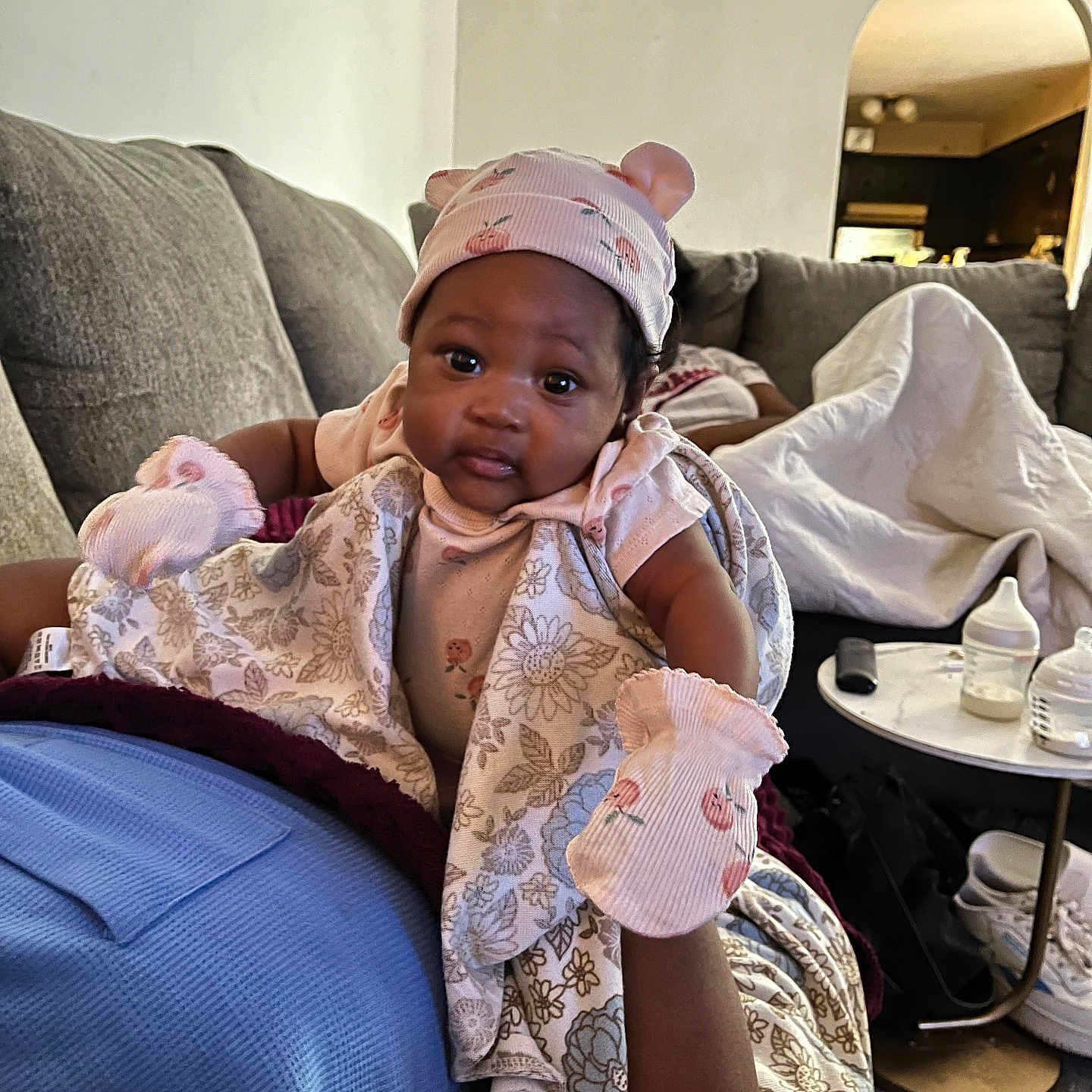 Keyshila joined the competition — help win amazing prizes! adult, baby, blanket, bottle, carpet, clothing, couch, face, floral_pattern, furniture, hand, hat, indoor, infant, living_room, mittens, person, relaxation, sneakers, table