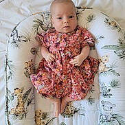 Maelia participe au concours pour gagner de l'argent avec cette photo : baby, infant, child, dress, floral_pattern, baby_nest, cushion, jungle_animals, giraffe, hippopotamus, leopard, zebra, tiger, pink, comfort, portrait, indoors, cute, small_hands, bare_feet