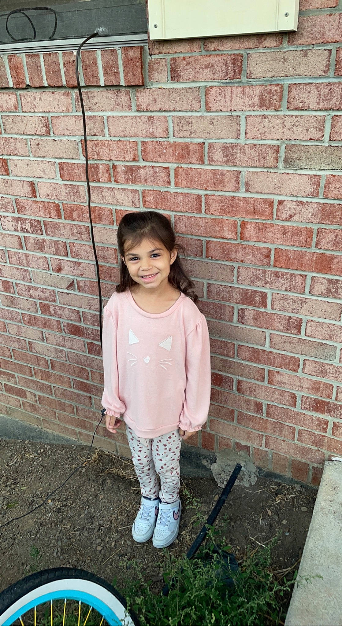 Aleena is registered to the contest to win money with this photo: bangs, brick, brickwork, child, concrete, denim, fashion_design, grass, happy, joy, magenta, pattern, person, pink, portrait_photography, sitting, sleeve, smile, standing, toy