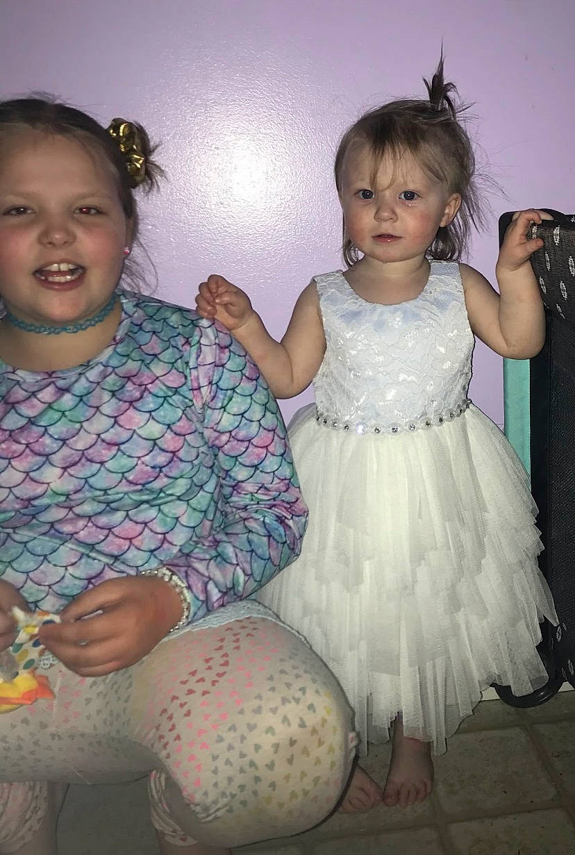 Maggie is registered to the contest to win money with this photo: arm, baby_toddler_clothing, eye, face, facial_expression, flash_photography, fun, gesture, hand, happy, head, human_body, iris, organ, person, pink, skin, standing, thigh, toddler