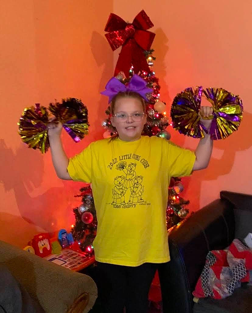 Maggie is registered to the contest to win money with this photo: costume_hat, couch, entertainment, event, fashion_accessory, fashion_design, fun, happy, hat, holiday, joy, magenta, party_supply, person, pink, room, smile, t_shirt, textile, tradition