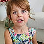 big_eyes, brown_hair, carpet, casual, child, colorful_dress, cute, earrings, flower, girl, happy, home, indoor, person, portrait, sitting, smiling, sofa, toddler, young