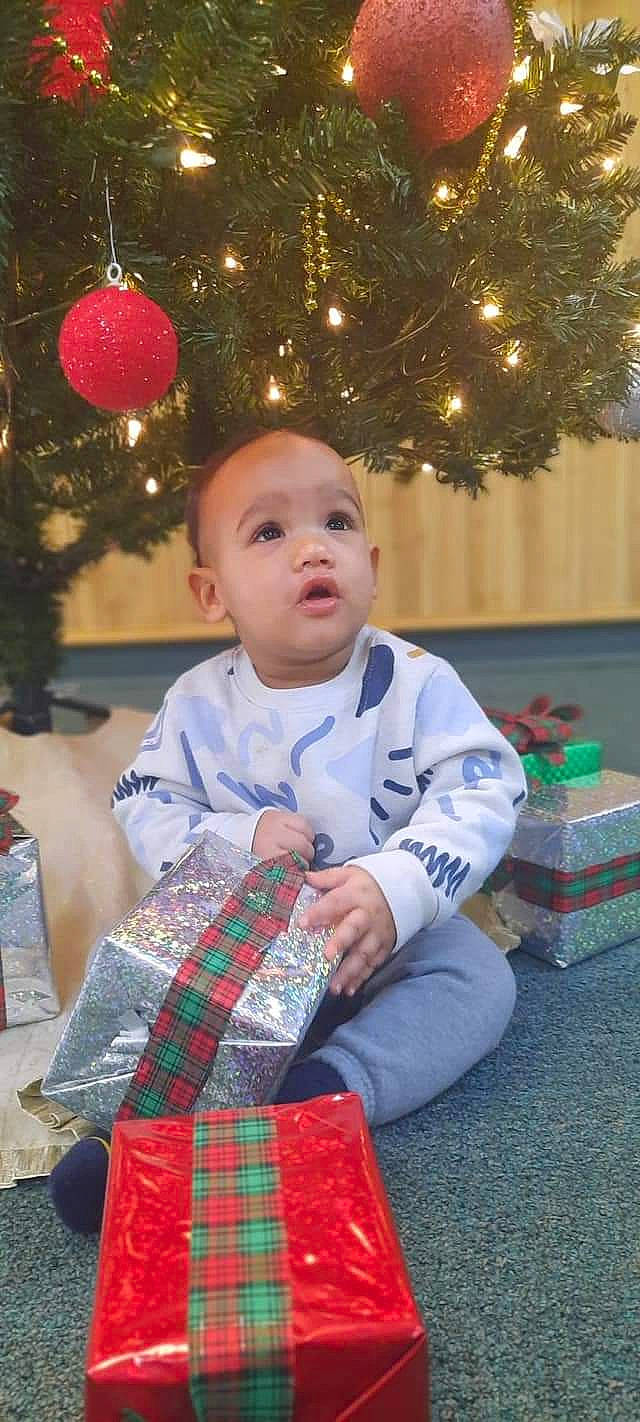 Jedidiah joined the competition — help win amazing prizes! baby, baby_toddler_clothing, child, christmas_decoration, christmas_ornament, christmas_tree, event, fun, green, happy, holiday, person, plaid, red, sleeve, snapshot, standing, tartan, toddler, tree