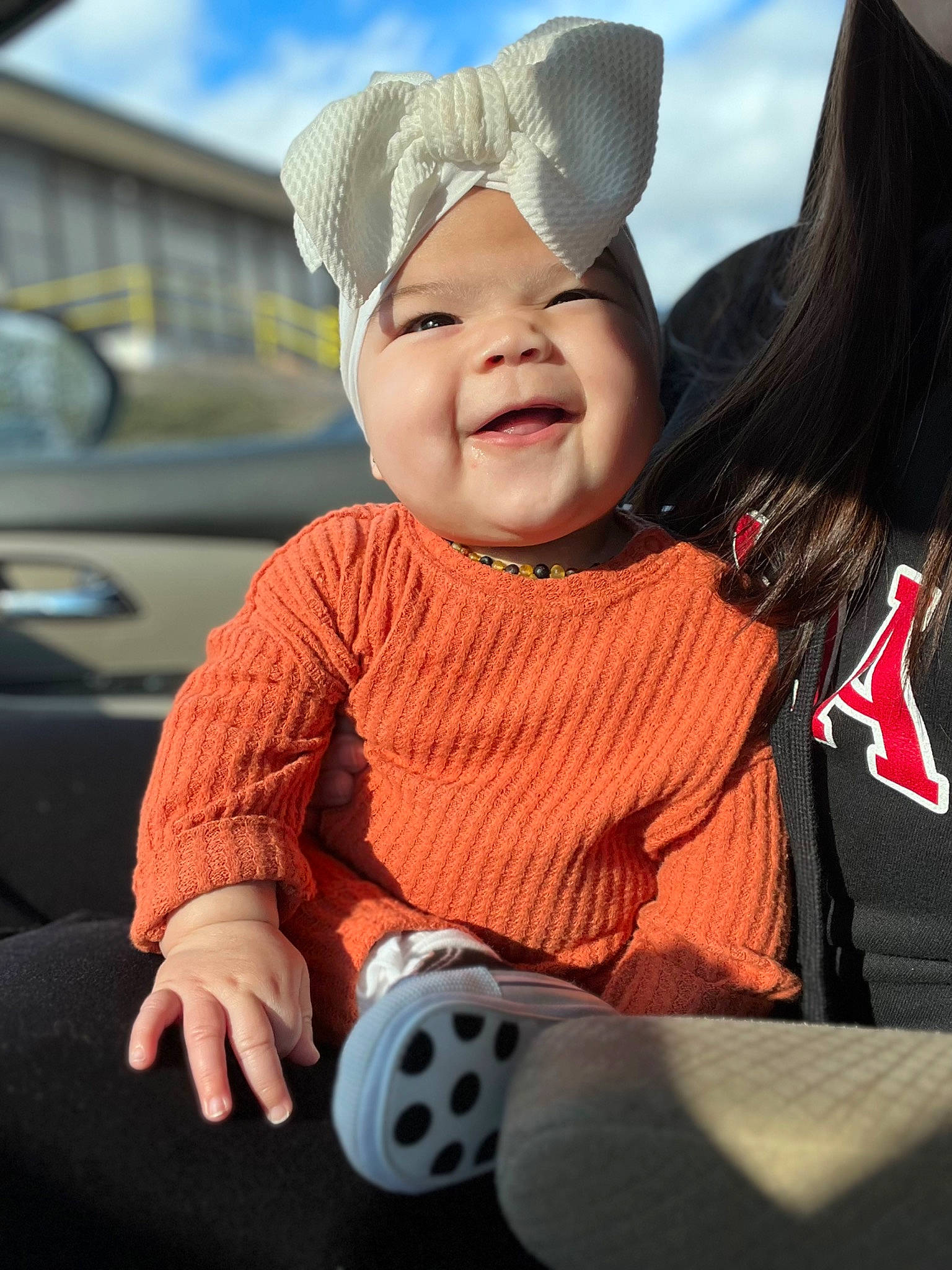 Klara joined the competition — help win amazing prizes! baby, baby_toddler_clothing, cap, carmine, child, cloud, face, fun, happy, hat, head, headwear, lap, lip, person, recreation, sitting, skin, sky, smile