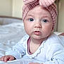 Eléa participe au concours pour gagner de l'argent avec cette photo : baby, bed, blanket, blue_eyes, child, closeup, cute, expression, face, hand, headband, indoors, infant, lying_down, person, pink_bow, portrait, skin, soft_light, white_clothing