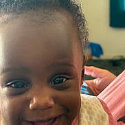 Bernadine joined the competition — help win amazing prizes! baby, cheeks, child, close_up, curly_hair, cute, eyes, face, happy, human, indoors, infant, joy, mouth, patterned_clothing, person, portrait, skin, smiling, young_child