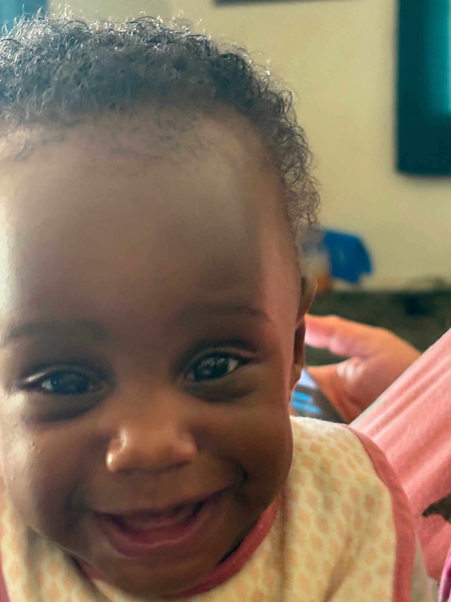 Bernadine joined the competition — help win amazing prizes! baby, cheeks, child, close_up, curly_hair, cute, eyes, face, happy, human, indoors, infant, joy, mouth, patterned_clothing, person, portrait, skin, smiling, young_child