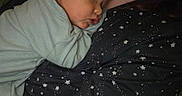 Kassian joined the competition — help win amazing prizes! baby, sleeping, child, person, face, clothing, star_pattern, shirt, cuddle, rest, comfort, indoor, closeup, skin, head, arm, young, peaceful, human, portrait