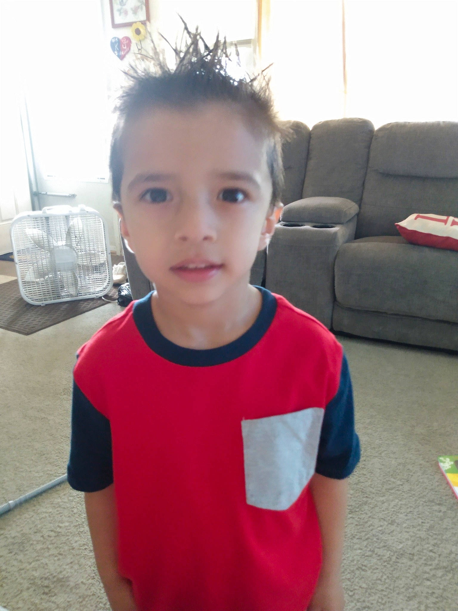 Connor is registered to the contest to win money with this photo: child, chin, cool, couch, eye, flooring, fun, happy, human_body, joint, leisure, mammal, person, room, shoulder, sleeve, t_shirt, toddler, travel, trunk