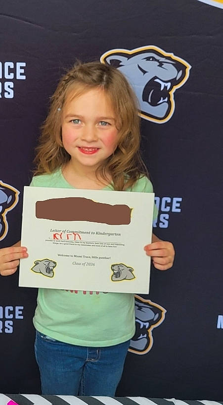 Kyrah is registered to the contest to win money with this photo: award, child, clothing, competition, event, fun, hairstyle, handwriting, happy, head, joy, logo, necklace, organ, person, recreation, sleeve, smile, t_shirt, top
