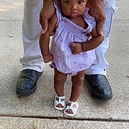 Mackenzie joined the competition — help win amazing prizes! toddler, child, adult_hands, white_pants, black_shoes, sidewalk, outdoor, dress, sandals, curly_hair, supporting, standing, concrete, person, baby, cute, small, walking, summer, daylight