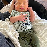 Jaxon joined the competition — help win amazing prizes! baby, blanket, closeup, clothing, cozy, cute, green_pants, hand, human, indoor, infant, newborn, peaceful, person, portrait, resting, sleeping, soft_lighting, striped_shirt, tender_moment