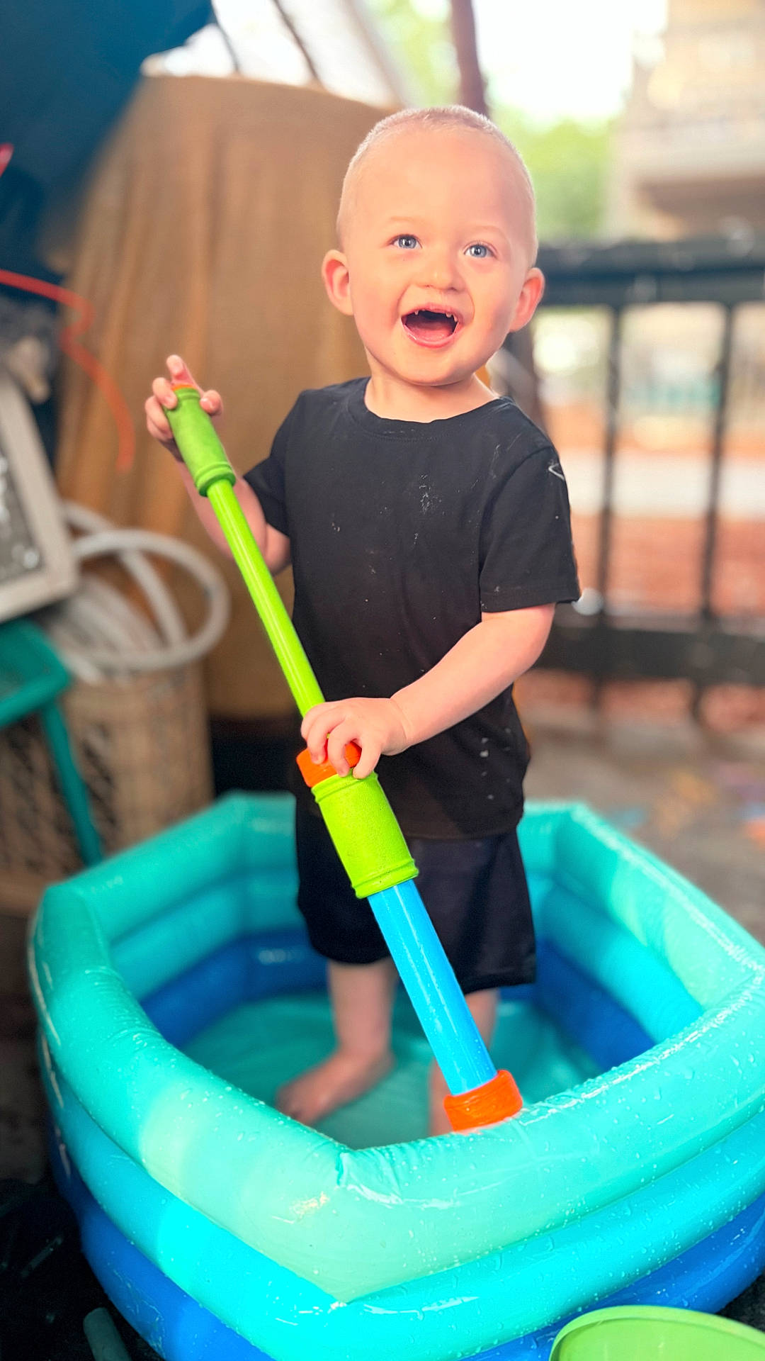Jaiden Slayer is registered to the contest to win money with this photo: barefoot, black_shirt, blue_eyes, bright, child, colorful, cute, fun, happy, indoor, inflatable_pool, play, shorts, smiling, summer, toddler, toy, water, water_toy, young_child