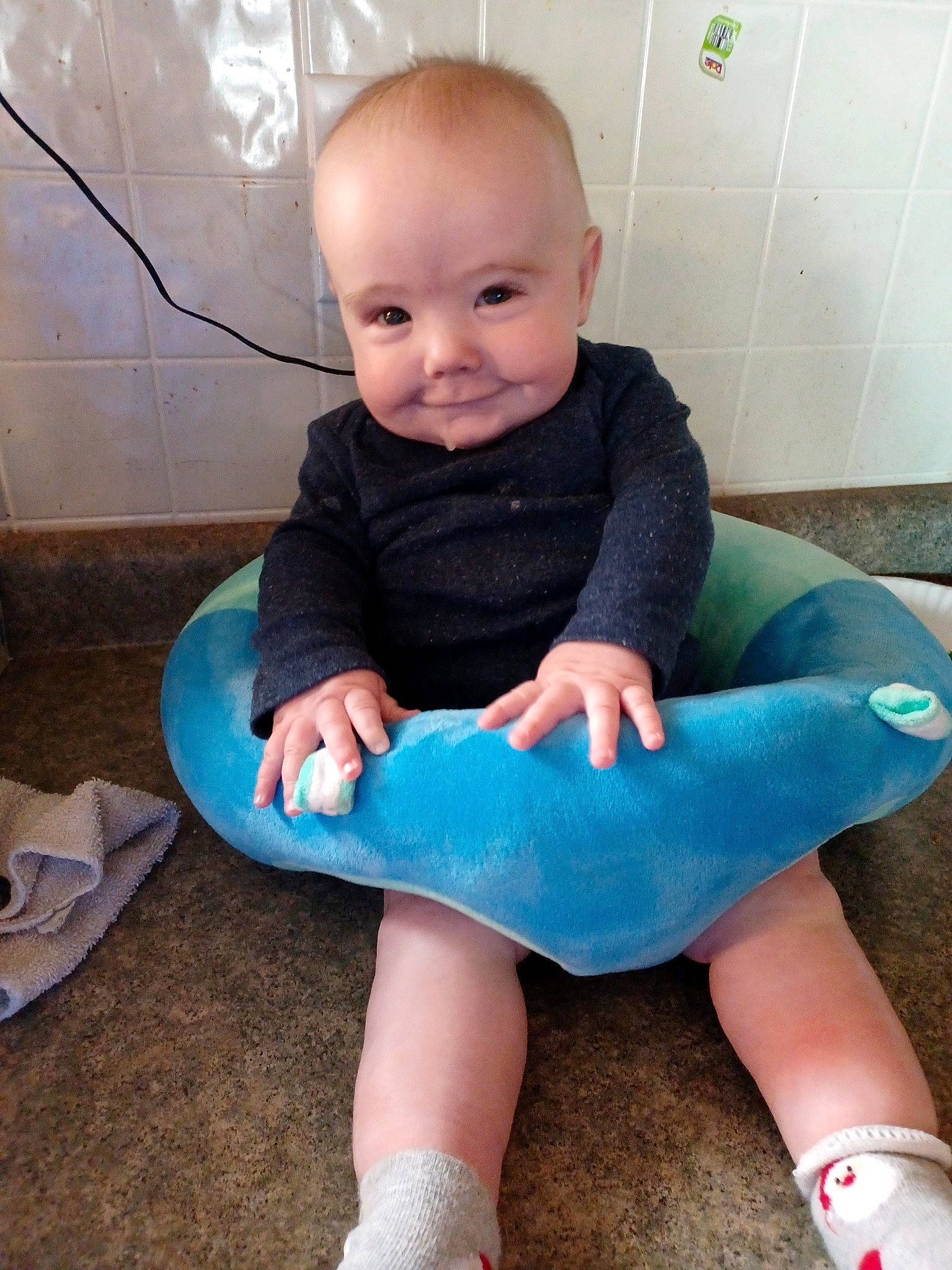 Logan is registered to the contest to win money with this photo: baby, baby_toddler_clothing, comfort, finger, human_body, iris, joint, knee, lap, leg, person, shoe, shoulder, skin, sleeve, smile, sock, standing, t_shirt, thigh