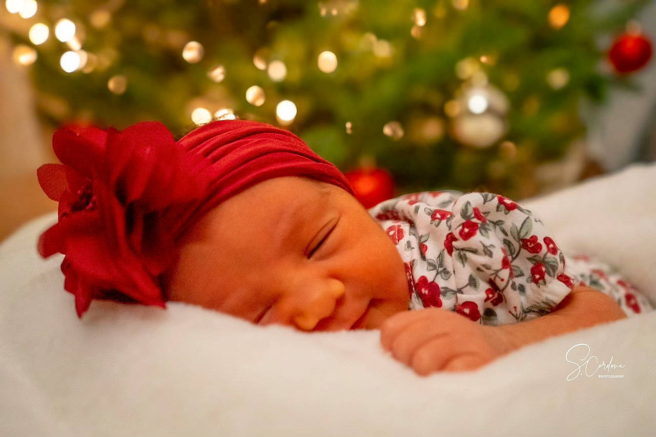 Valentina is registered to the contest to win money with this photo: baby, baby_sleeping, baby_toddler_clothing, carmine, child, comfort, event, fashion_accessory, grass, hair_accessory, happy, headwear, holiday, knit_cap, linens, lip, pattern, people_in_nature, person, portrait_photography