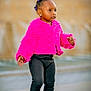 black_leggings, child, colorful_boots, confident, cute, daylight, earrings, fashion, fluffy_jacket, fuzzy_boots, hair_beads, outdoor, pavement, pink_jacket, purple_beads, side_profile, street, toddler, walking, young_child