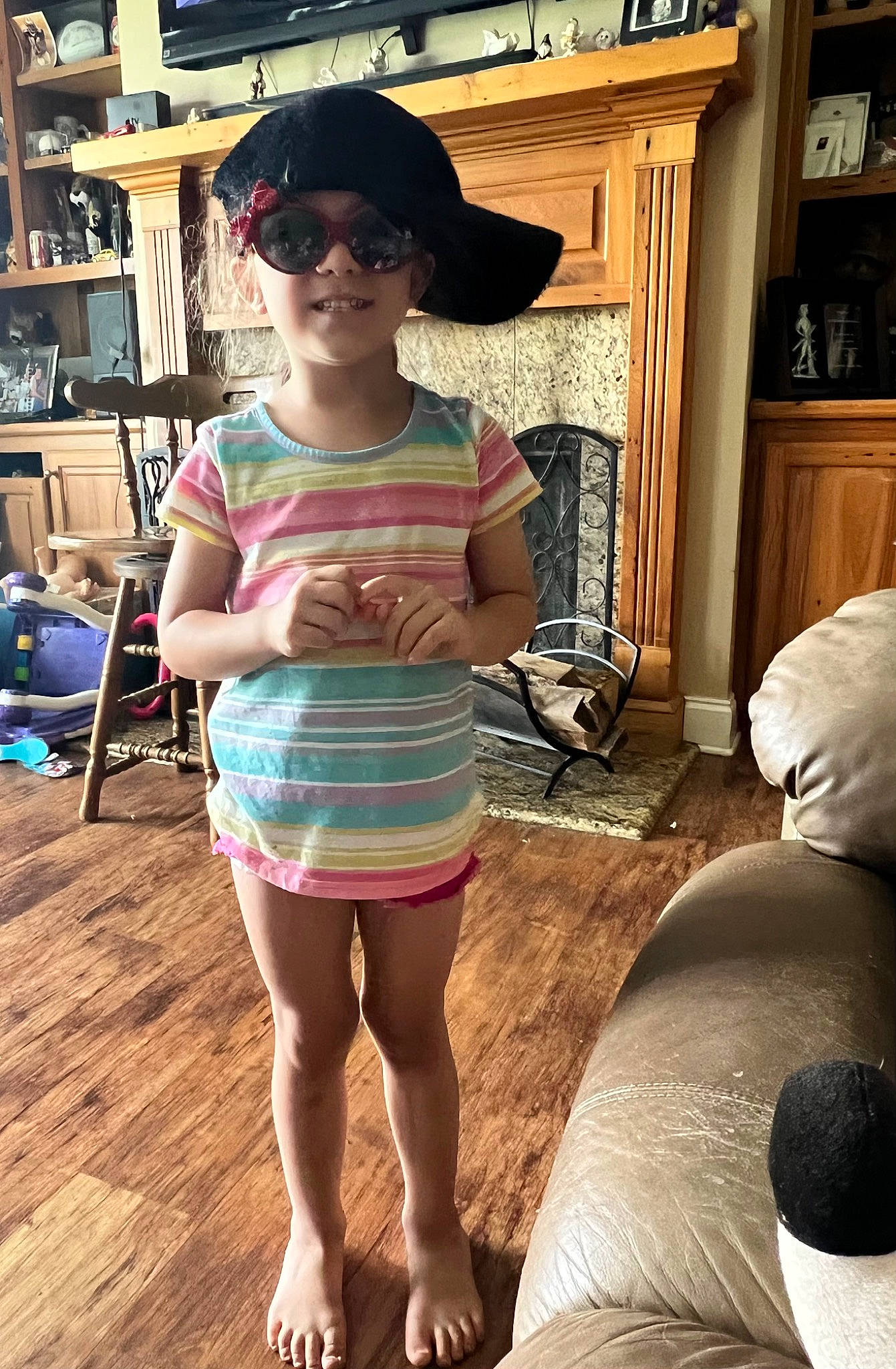 Madison joined the competition — help win amazing prizes! blurred, bookcase, cap, eyewear, flooring, fun, glasses, goggles, hairstyle, happy, hat, headwear, joy, leg, leisure, person, picture_frame, shelf, smile, sun_hat