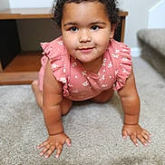 Nova joined the competition — help win amazing prizes! toddler, child, crawling, pink_dress, carpet, indoor, furniture, curly_hair, portrait, young_child, smiling, cute, baby, home, person, carpeted_stairs, wooden_furniture, floor, expression, closeup