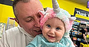 Rebekah is registered to the contest to win money with this photo: baby, man, unicorn_hat, smile, happy, child, person, indoor, store, shelf, clothing, hoodie, colorful, portrait, cute, holding, bright, background, retail, shopping