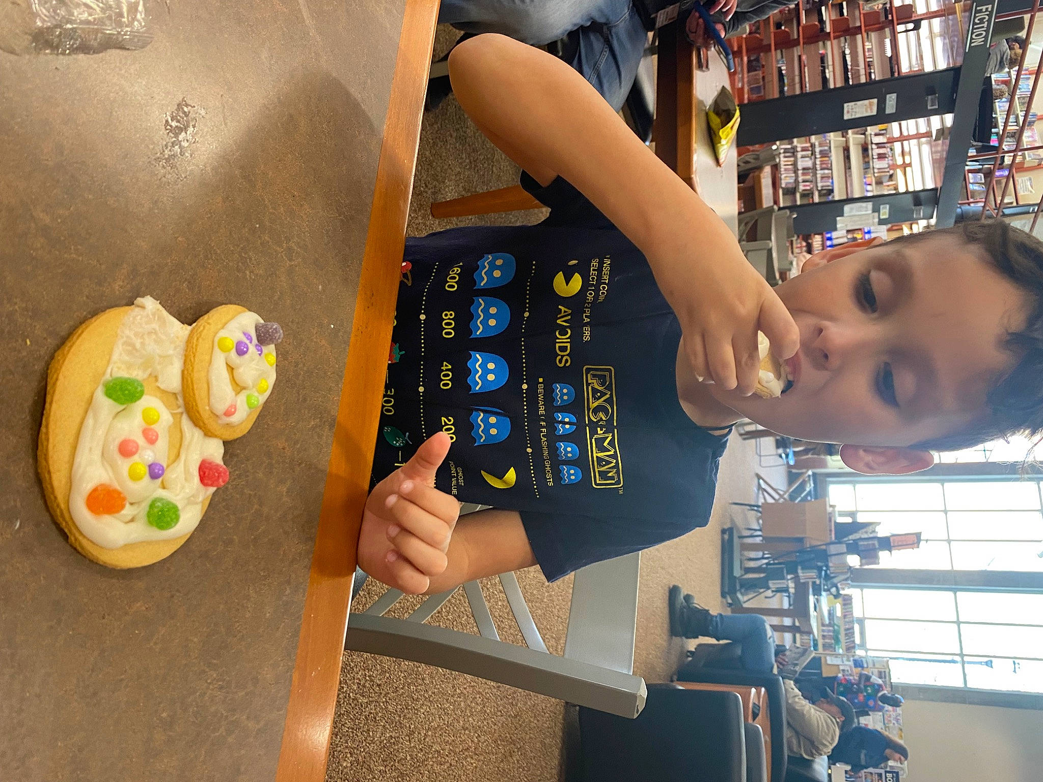 Mateo is registered to the contest to win money with this photo: child, comfort_food, customer, engineering, eyewear, finger, fun, gadget, games, gesture, leisure, machine, nail, person, play, product, publication, room, shelf, shelving