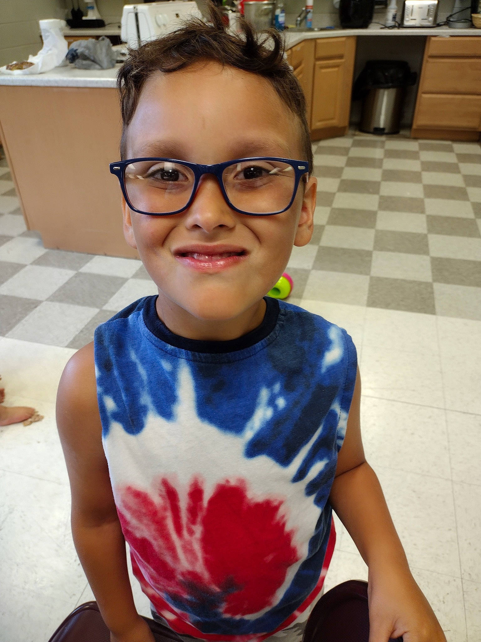 Mateo joined the competition — help win amazing prizes! chair, child, chin, electric_blue, eyewear, flooring, fun, glasses, happy, head, joy, leisure, neck, person, personal_protective_equipment, room, sleeve, smile, snapshot, sportswear