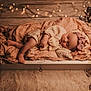baby, sleeping, teddy_bear, blanket, headband, knitwear, cozy, wooden_drawer, fairy_lights, soft_lighting, indoor, decor, floor, rug, flowers, peaceful, infant, portrait, cute, resting