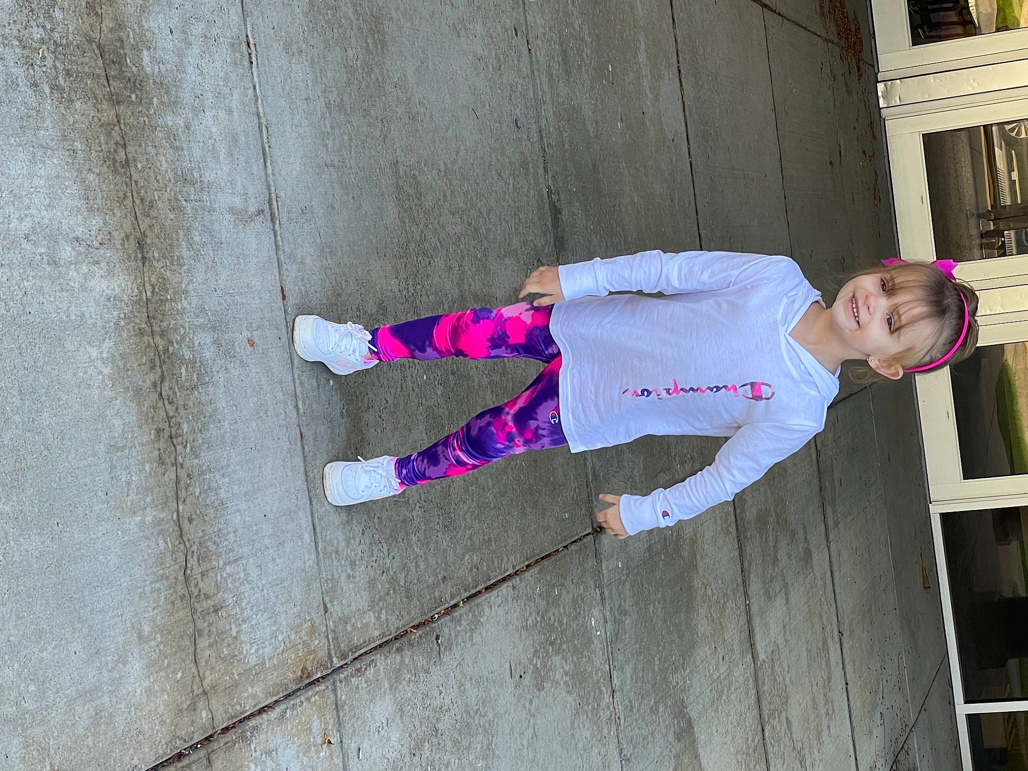 Lilee is registered to the contest to win money with this photo: baby_toddler_clothing, carmine, child, concrete, costume, flooring, fun, human_leg, joy, magenta, pattern, person, pink, road_surface, sleeve, sock, sweatpant, thigh, toddler, walking_shoe
