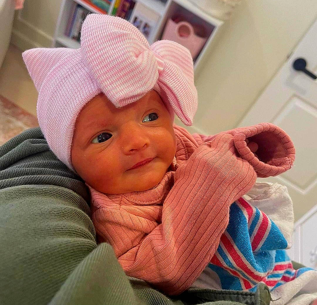 Emma is registered to the contest to win money with this photo: baby, baby_products, baby_safety, baby_sleeping, baby_toddler_clothing, cap, cheek, child, comfort, eyebrow, eyelash, fashion_accessory, hat, headwear, knit_cap, linens, person, skin, sleeve, thumb