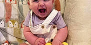 Charlotte joined the competition — help win amazing prizes! animal_pattern, baby, blanket, child, clothing, couch, cute, expression, hair_clips, happy, indoor, infant, joyful, pillow, playing, portrait, sitting, smiling, socks, toy