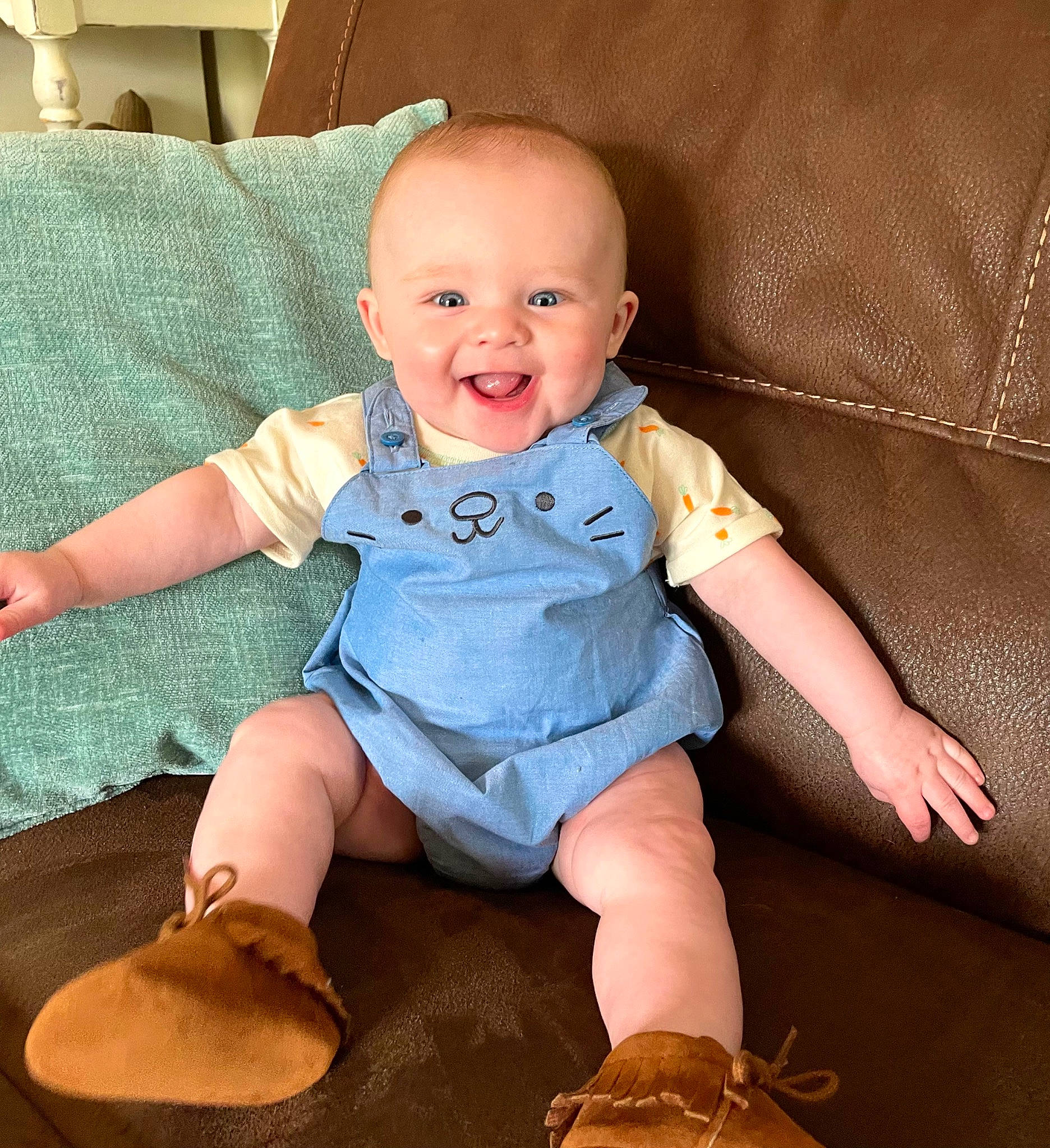 Silas joined the competition — help win amazing prizes! baby, baby_toddler_clothing, cheek, child, comfort, couch, eye, finger, happy, head, human_leg, iris, joy, knee, lap, leg, person, skin, sleeve, smile