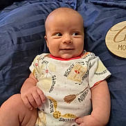 Matthew joined the competition — help win amazing prizes! baby, baby_boy, baby_girl, bed, blanket, child, clothing, cute, happy, harry_potter, infant, lying_down, milestone, onesie, person, portrait, skin, smile, two_months, wooden_plaque