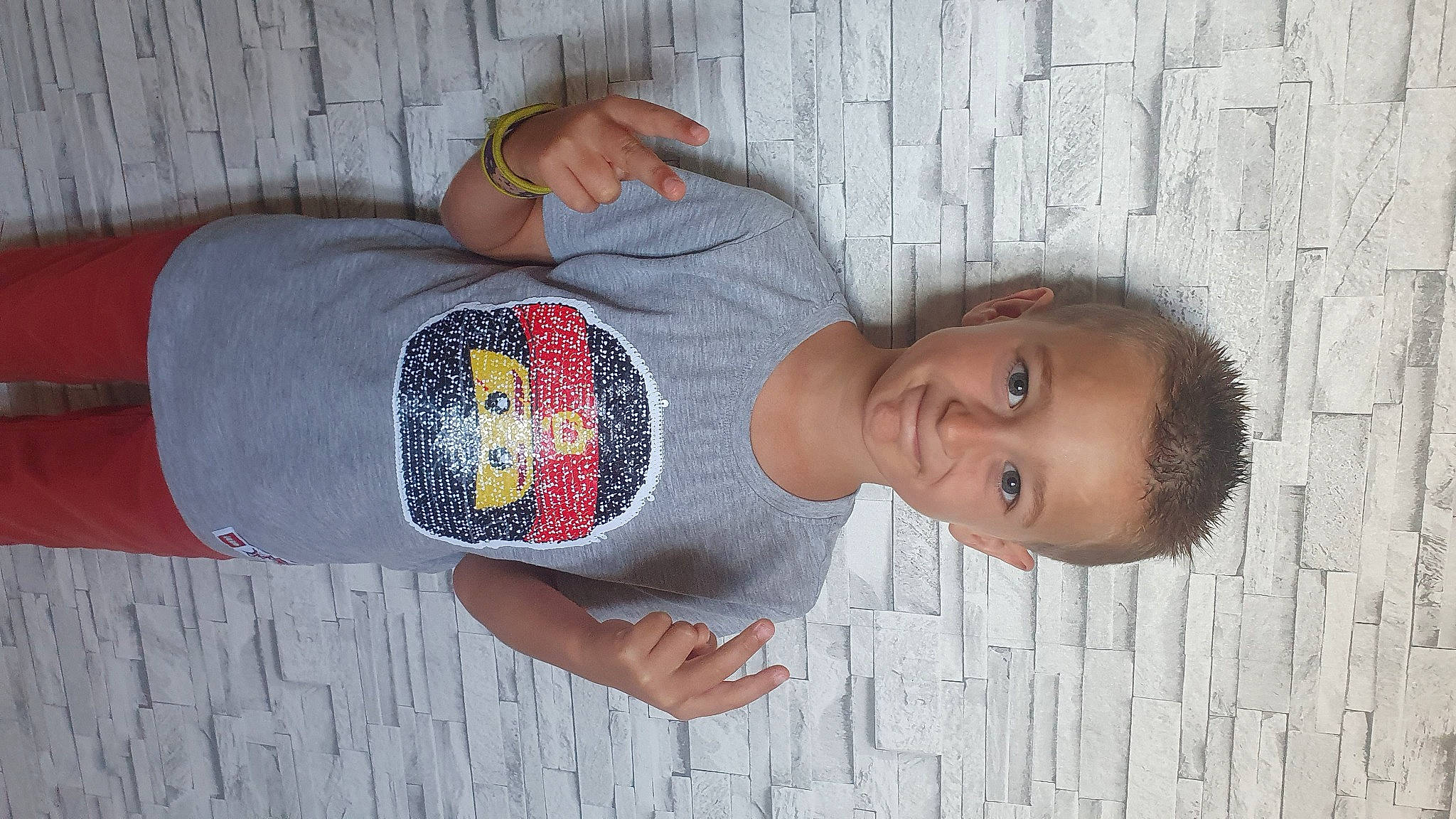 Julien participe au concours pour gagner de l'argent avec cette photo : elbow, finger, gesture, hand, human_body, human_leg, joint, joy, neck, organ, person, shoulder, sleeve, street_fashion, t_shirt, textile, trunk, vertebrate, waist, wall