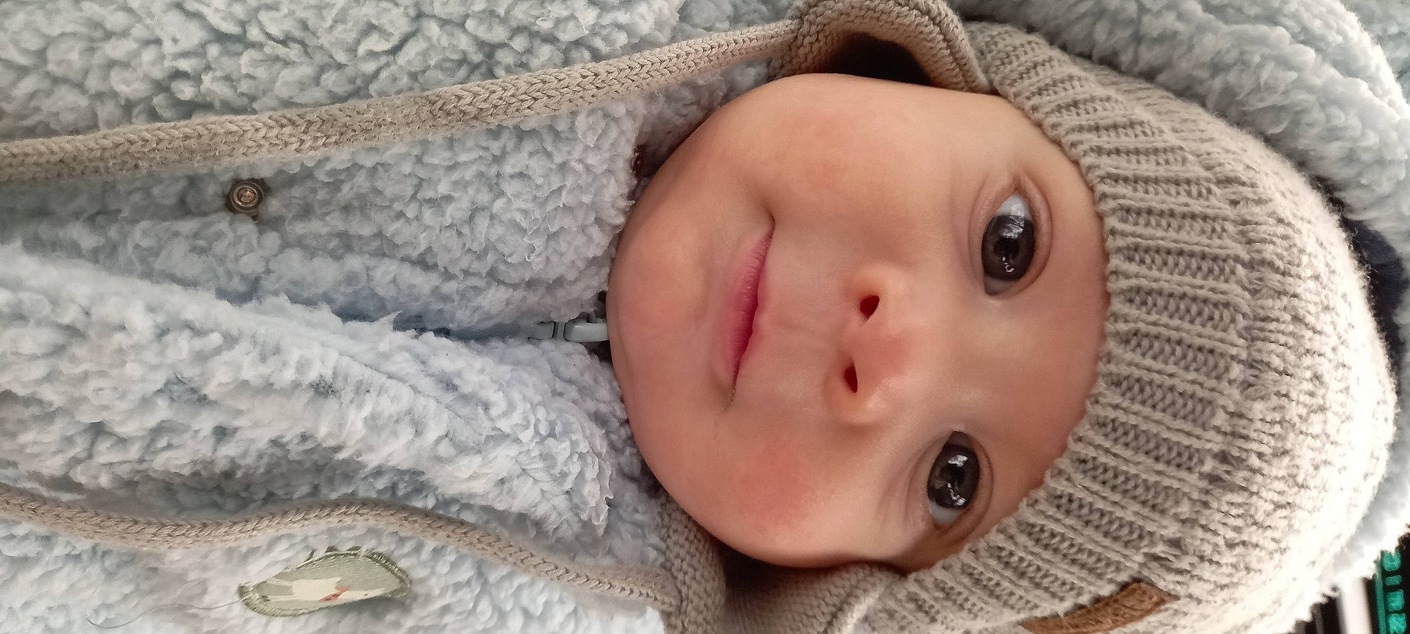 Pharrell participe au concours pour gagner de l'argent avec cette photo : baby, baby_sleeping, baby_toddler_clothing, cheek, child, comfort, eyebrow, eyelash, fur, headwear, human_body, iris, knit_cap, linens, lip, mouth, nose, person, portrait_photography, skin