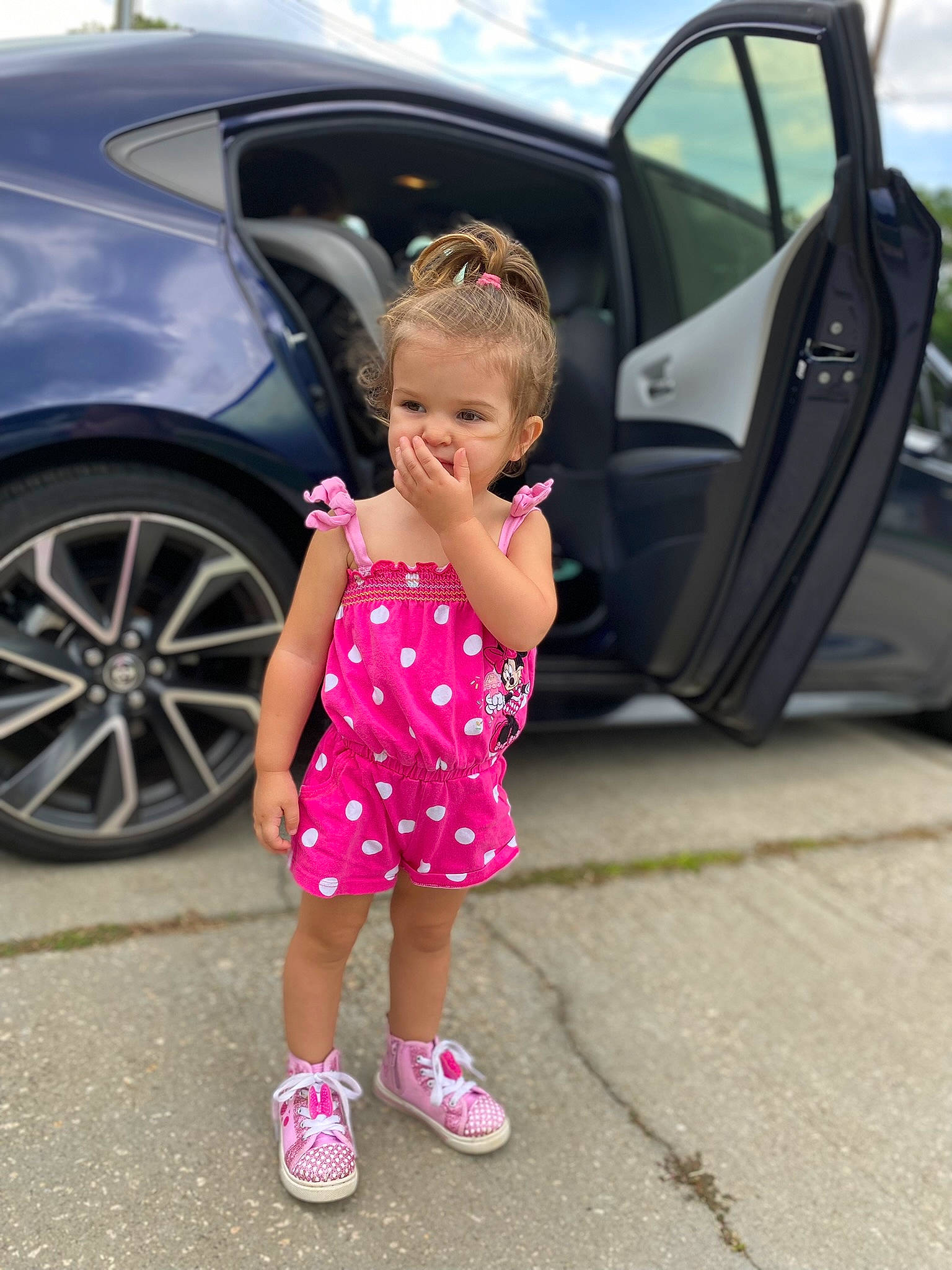 Emma joined the competition — help win amazing prizes! alloy_wheel, automotive_design, automotive_exterior, automotive_lighting, automotive_tire, bumper, car, cloud, fender, hood, motor_vehicle, person, pink, rim, shoe, sky, tire, toddler, vehicle, vehicle_door