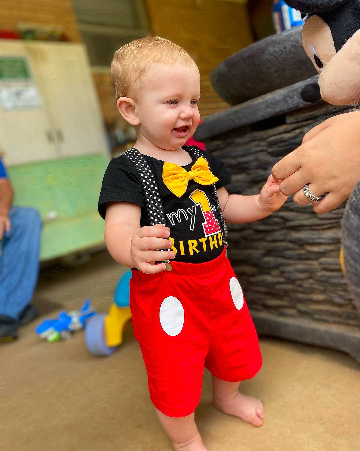 Rivers is registered to the contest to win money with this photo: baby, baby_toddler_clothing, child, event, flooring, fun, gesture, happy, human_leg, joint, leg, leisure, person, play, sitting, sportswear, standing, sweatpant, t_shirt, thigh