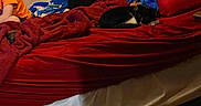 Babygirl is registered to the contest to win money with this photo: bed_sheet, comfort, curtain, electric_blue, hardwood, hat, human_leg, leisure, linens, paint, room, sitting, tints_and_shades, wood