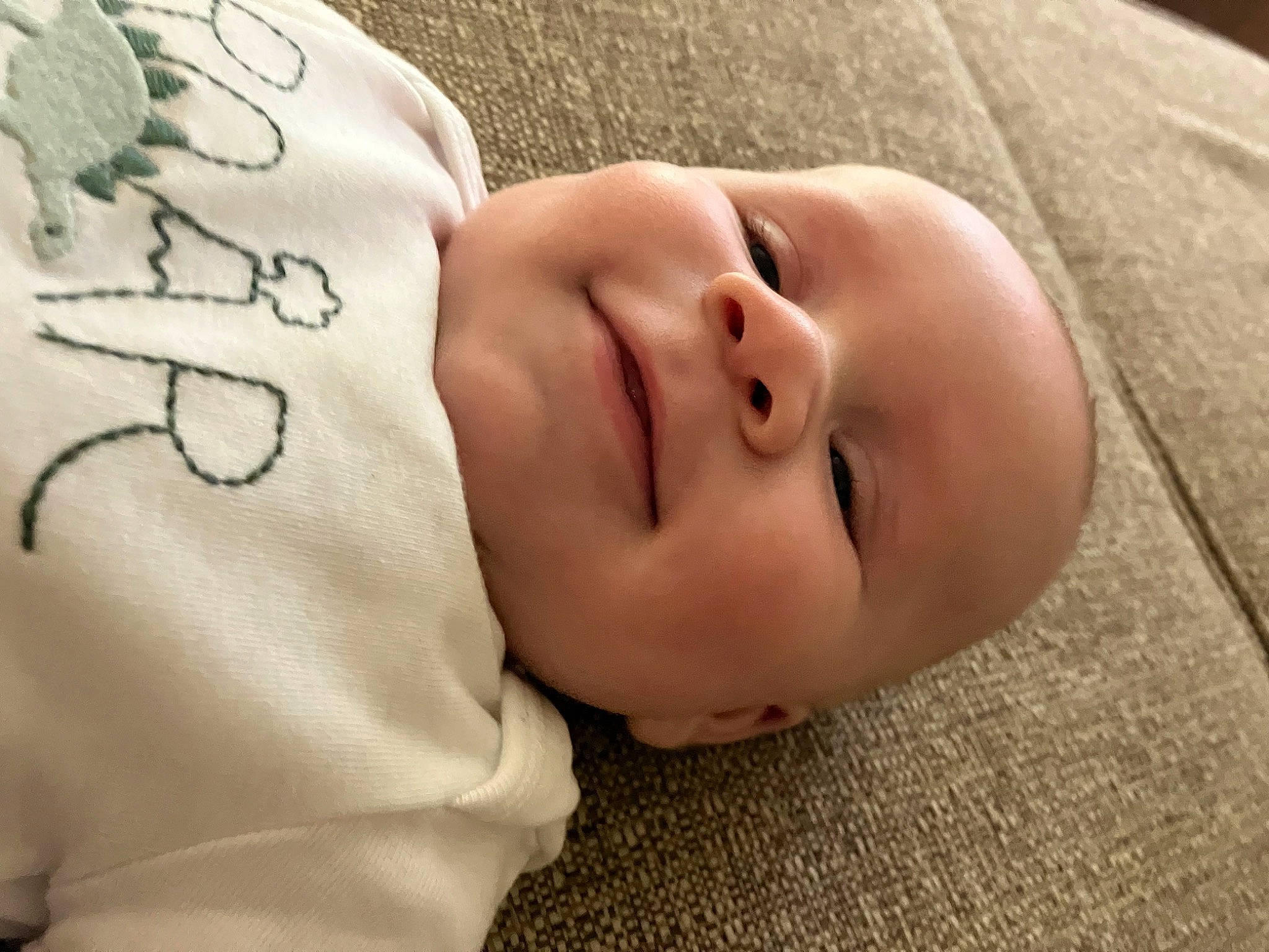 Colton is registered to the contest to win money with this photo: baby, baby_toddler_clothing, bedtime, cheek, child, comfort, eyelash, face, flesh, grass, happy, head, linens, nose, pattern, person, portrait_photography, skin, sleeve, toddler