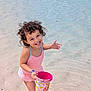 Serena participe au concours pour gagner de l'argent avec cette photo : child, toddler, beach, water, sand, swimsuit, bucket, unicorn, curly_hair, play, happy, smiling, summer, outdoor, fun, toy, shallow_water, cute, vacation, sunny
