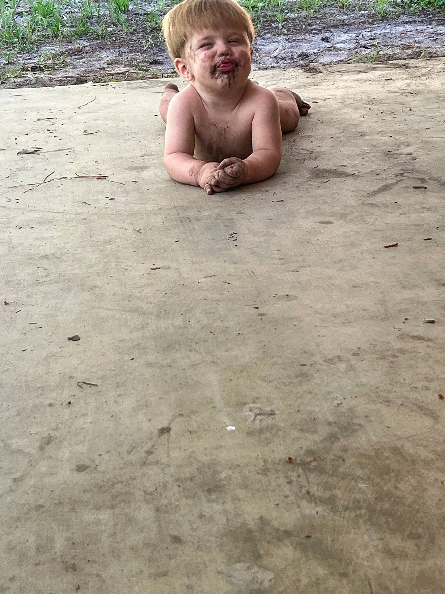 barefoot, child, concrete, dirt, face, funny_face, grass, ground, happy, messy, mud, naked, nature, outdoor, person, playful, skin, smile, summer, toddler
