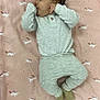 baby, sleeping, blanket, unicorn, pajamas, socks, infant, child, cute, cozy, lying_down, peaceful, hand, face, small_person, indoors, soft, pattern, resting, comfort