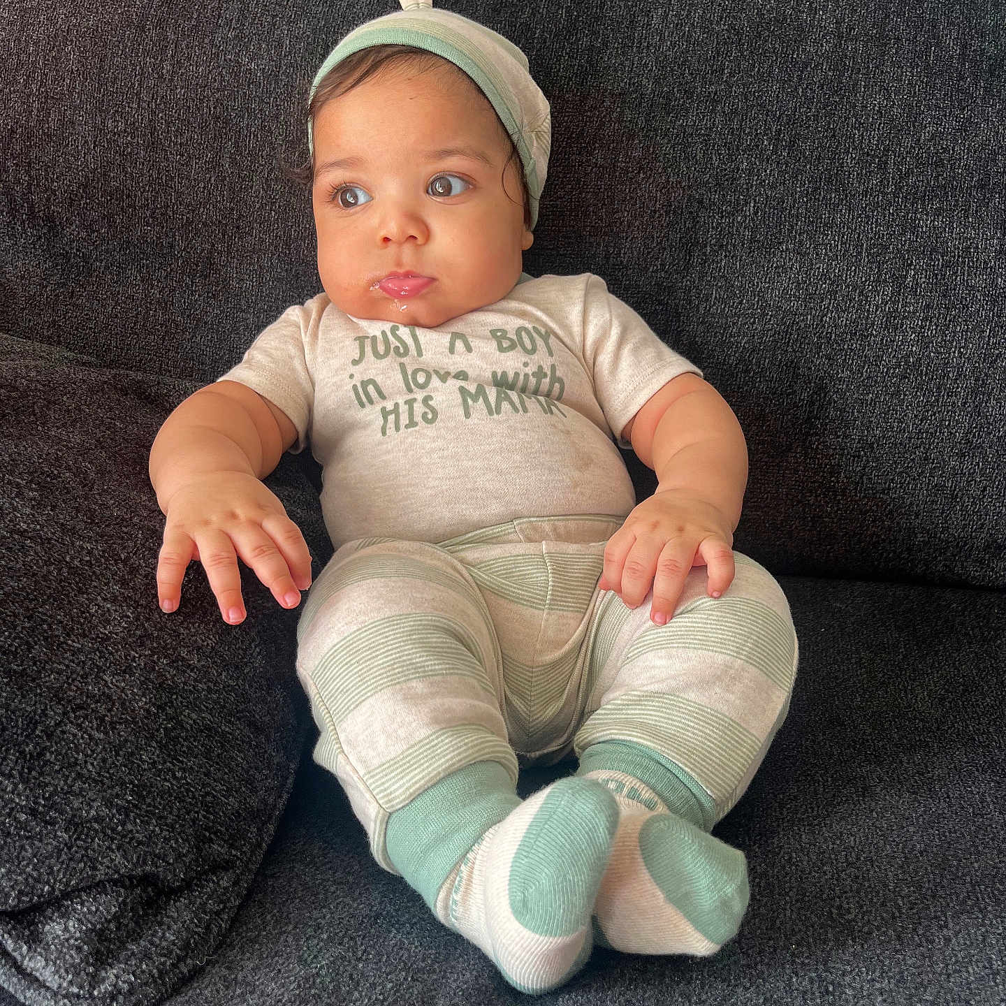 Onyx is registered to the contest to win money with this photo: baby, baseballcap, bodypart, cap, clothing, couch, cushion, face, finger, furniture, hat, head, homedecor, hosiery, pants, person, photography, portrait, sitting, sock