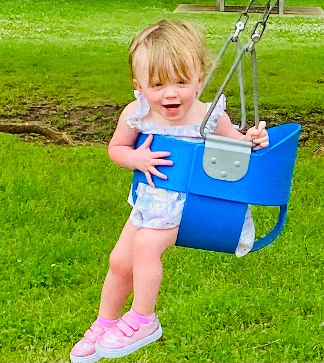 Raelynn is registered to the contest to win money with this photo: baby_toddler_clothing, child, electric_blue, fun, grass, grassland, happy, lawn, leisure, meadow, nature, outdoor_play_equipment, people_in_nature, person, plant, play, recreation, smile, summer, t_shirt