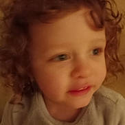 Harper joined the competition — help win amazing prizes! child, toddler, curly_hair, face, portrait, close_up, indoor, warm_lighting, soft_focus, person, young_child, casual_clothing, cute, expression, head_and_shoulders, skin, human, baby, looking_away, blurry