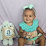 baby, child, toddler, smiling, headband, bow, polka_dot, dress, stuffed_animal, bunny, milestone_sign, fabric_backdrop, carpet, sitting, cute, indoor, portrait, happy, soft_toys, baby_girl