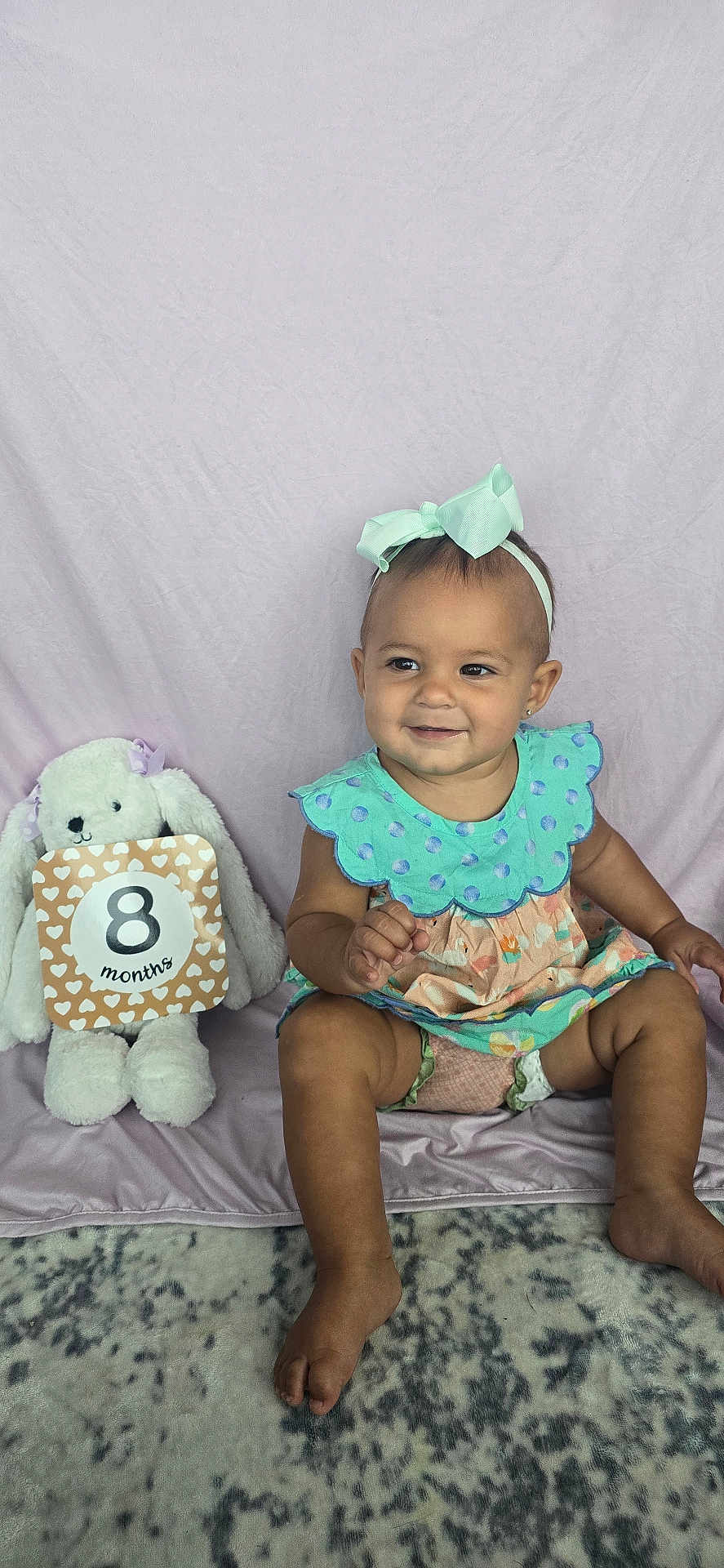 Everly joined the competition — help win amazing prizes! baby, child, toddler, smiling, headband, bow, polka_dot, dress, stuffed_animal, bunny, milestone_sign, fabric_backdrop, carpet, sitting, cute, indoor, portrait, happy, soft_toys, baby_girl