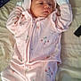 baby, bed, blanket, child, cute, fabric, indoor, infant, lying_down, mitten, newborn, onesie, peaceful, person, pink_clothing, quilt, sleepwear, sleepy, soft_lighting, strawberry_pattern