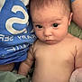Maielynn joined the competition — help win amazing prizes! baby, infant, diaper, person, blue_shirt, blanket, skin, eyes, face, expression, lying_down, indoor, child, young, portrait, human, casual, close_up, candid, resting