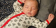 Timothy joined the competition — help win amazing prizes! baby, sleeping, onesie, animal_print, red_trim, blanket, pillow, bed, cozy, peaceful, infant, child, cute, resting, indoors, soft, comfortable, young, face, hand